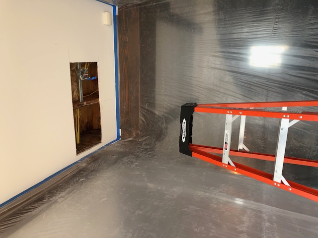 Water damaged section of ceiling removed to prevent mold growth